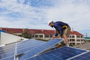 Working installing commercial solar power panels