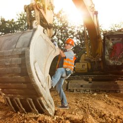 repairman fixing excavator